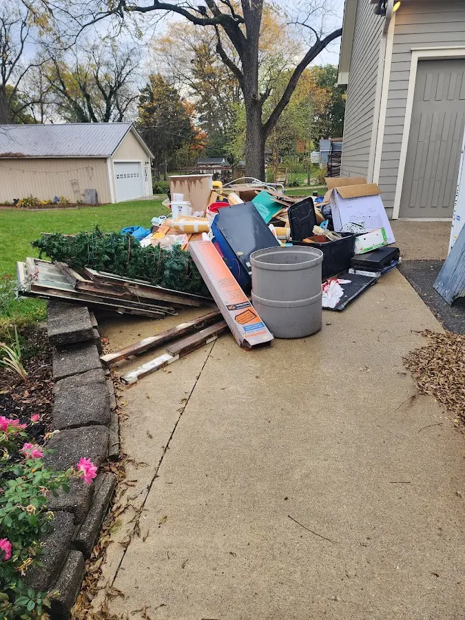 Dumpster being loaded with debris for Estate Cleanout Dumpster Rental in River Edge